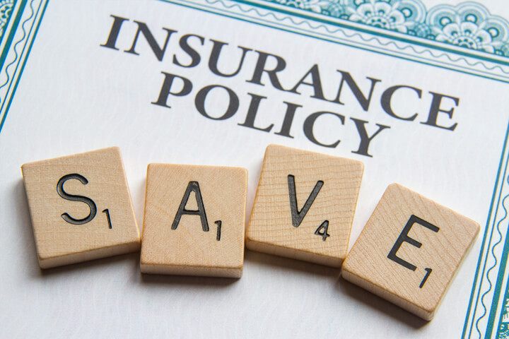 Insurance policy with Scrabble letters reading SAVE concept for saving money on insurance