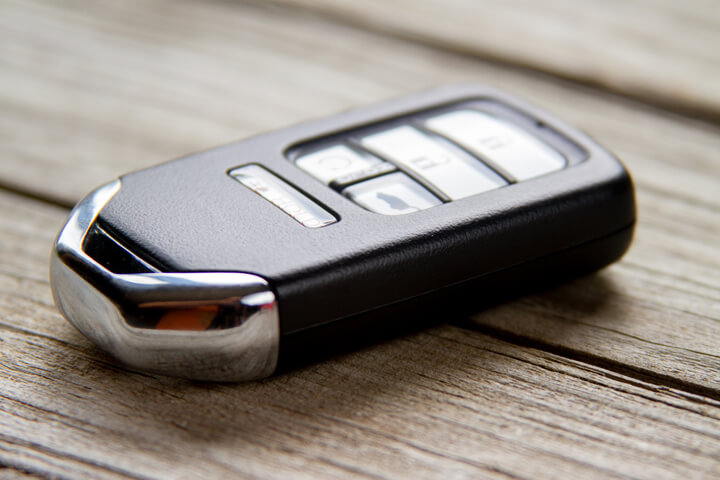 Photo of a vehicle keyless entry remote on weathered wood planks