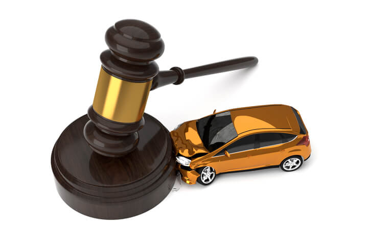 Small orange car crashed into side of gavel view from top liability concept image
