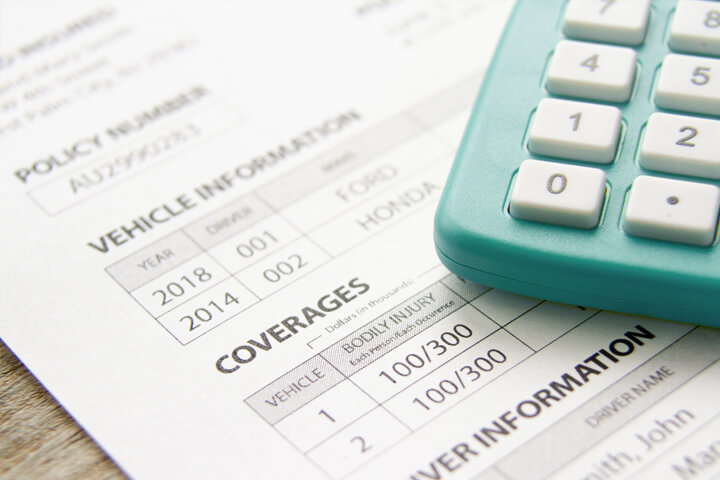 Photo of a car insurance policy with a calculator