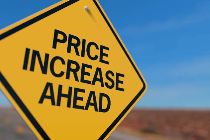 Yellow road sign reading Price Increase Ahead concept for upcoming insurance rate increase