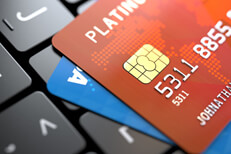 Credit cards on laptop keyboard Two credit cards on dark laptop keyboard at angle concept for online purchase or credit report