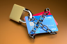 Credit cards padlocked and chained on orange background