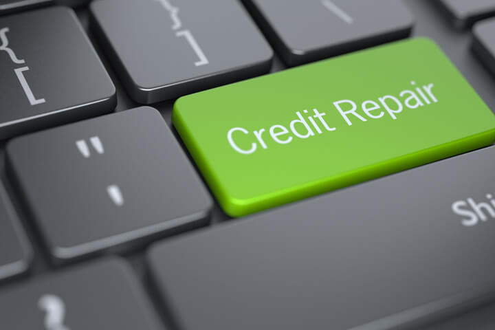 Concept image of credit repair with dark laptop keyboard