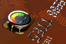 Close up of credit card EMV chip with credit score gauge showing good credit rating
