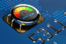 Close up of credit card EMV chip with chrome speedometer style gauge showing good credit score