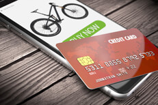 Buy now mobile credit card on wood iPhone showing buy now screen with credit card on weathered wood surface