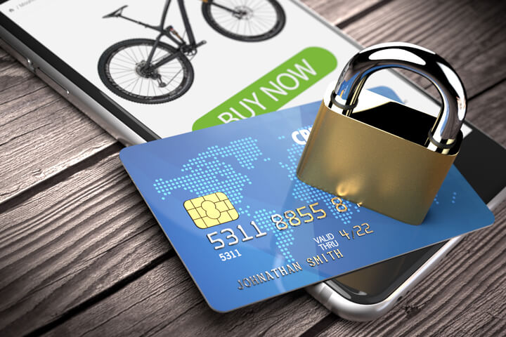 iPhone showing buy now screen with credit card and padlock on weathered wood planks