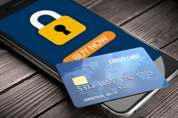 Mobile phone showing secure padlock icon with buy button and credit card