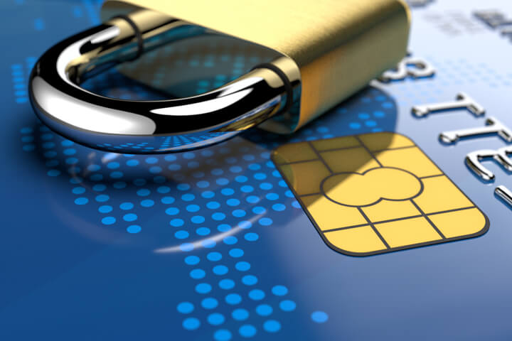 Angled view of shiny padlock on blue credit card showing gold EMV chip