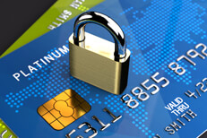 Small padlock on credit cards Two angled credit cards on dark background with small padlock on top