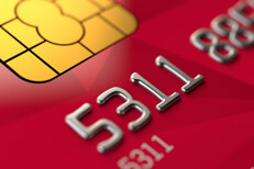 Close up view of red credit card EMV chip and credit card number
