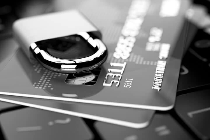 Credit cards on keyboard with padlock in black and white