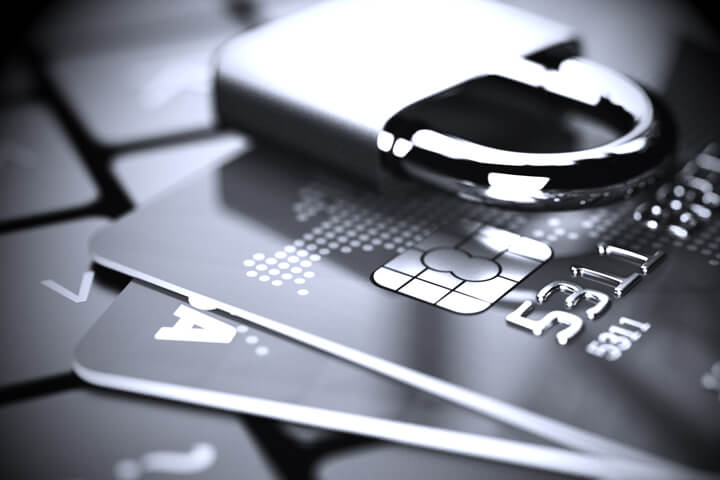 Credit cards on laptop with padlock in black and white with vignette
