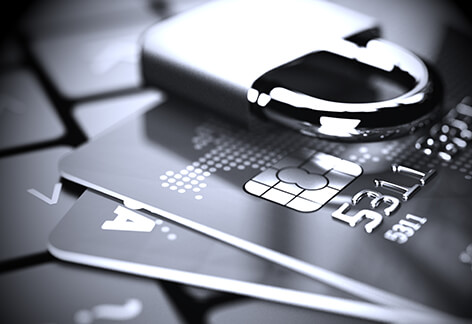 Credit cards on laptop with padlock in black and white with vignette