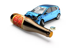 Blue car crashed into beer bottle laying on side concept for drunk driving or DUI