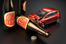 Red car crashed into beer bottle laying on side concept for drunk driving or DUI with dark background