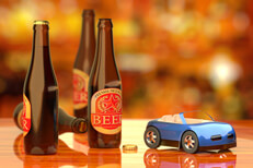 Beer bottles on bar next to blue toy car concept for drinking and driving or driving while intoxicated