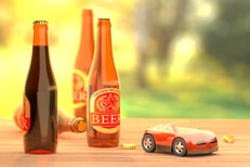 Beer bottles on table outside with red toy car concept for driving under the influence or drunk driving