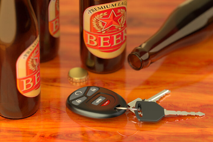 Beer bottles on bar with car keys concept for DUI, driving while intoxicated, or driving under the influence