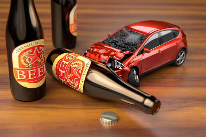 Small car crashing into a beer bottle on bar top