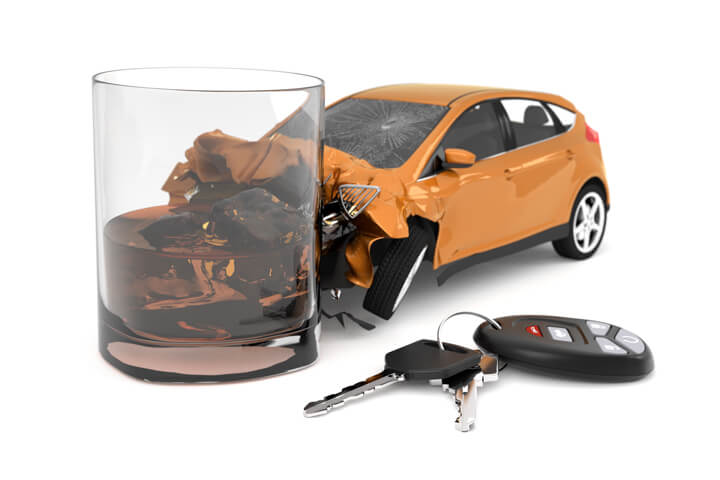 Orange compact car smashed into whiskey glass with car keys and key fob