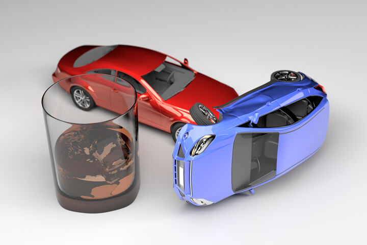 Car accident next to glass of whiskey from drunk driving