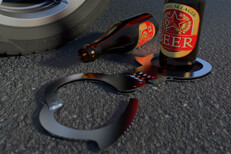 Beer bottles with handcuffs on street next to car tire and wheel DUI arrest concept photo