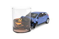 Drunk driving concept showing compact car crashed into glass of whiskey isolated on white background
