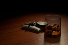 Drunk driving concept showing a whiskey glass on bar with wallet and car keys another view