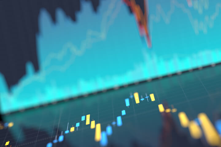 Computer screenshots of area and candlestick charts for stock prices reflected