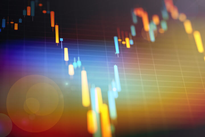 Closeup of candlestick stock price chart with lens flare and overlay