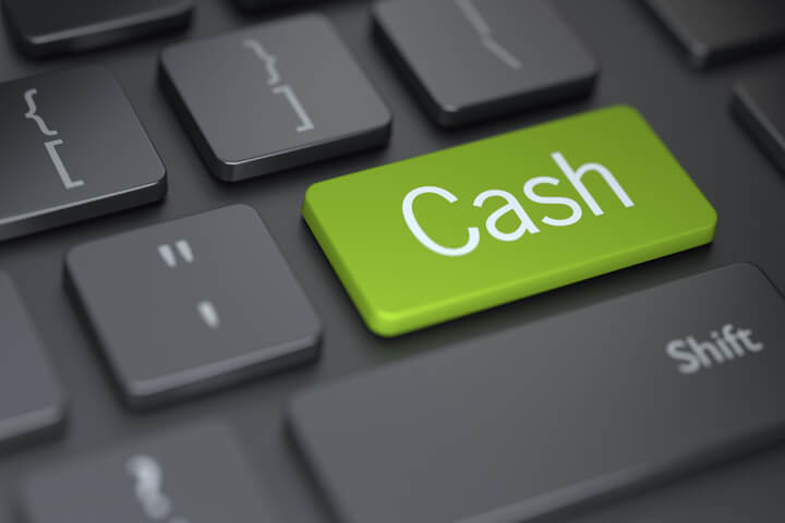 Dark keyboard with large green Cash button concept for putting investments into cash