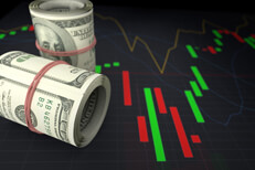 Concept image showing two rolls of currency on stock chart to illustrate buying stocks or stay in cash