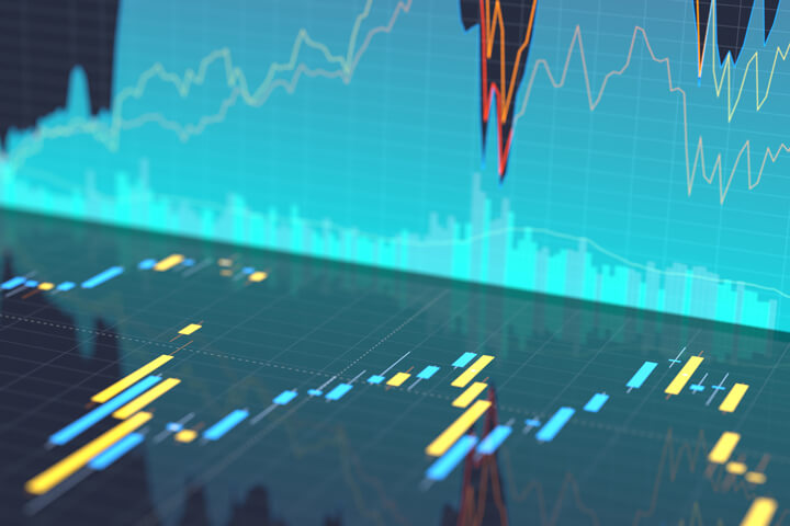 Stock price area chart reflecting into glossy surface showing stock price candlestick chart