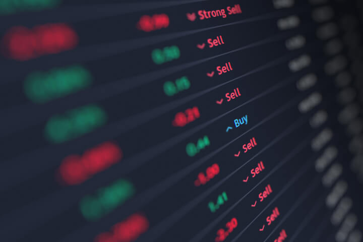 Stock ticker listings with focus on buy/sell recommendations with other information blurred