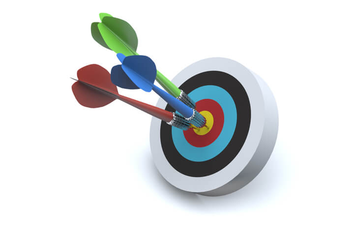 Three colorful darts all hit center of target