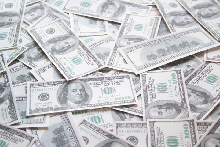 Thousands of dollars in $100 bills scattered on ground