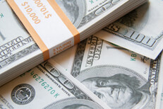 Banded bundle of $10,000 on top of other $100 bills