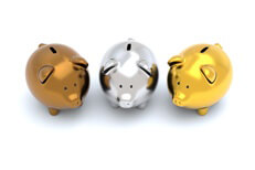 Three piggy banks one bronze, one silver, one gold isolated on white background