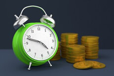 Concept image with clock and stacks of gold coins for savings, time value of money, or compound interest