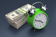 Concept image of clock and stacks of bills on dark background demonstrating cost over time or time is money