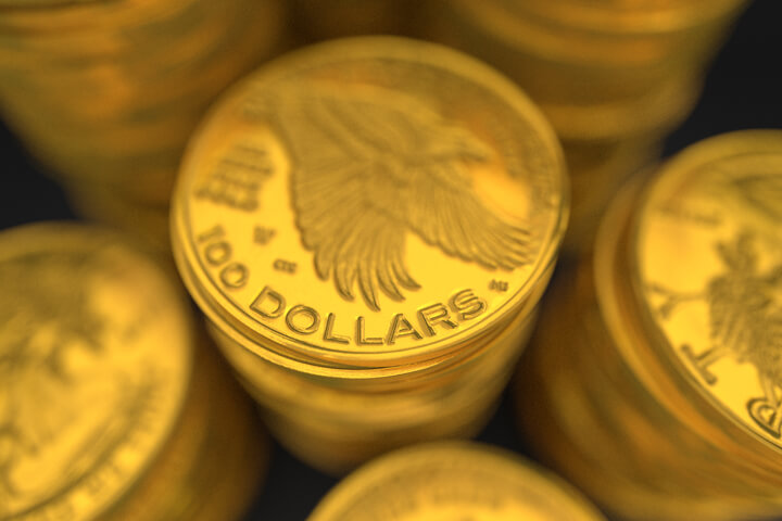 Close-up image of stacks of 100 dollar U.S. gold coins