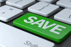 Laptop keyboard with large green button with word SAVE representing online savings or save money online