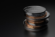 Small stack of assorted U.S. coins on dark shiny background