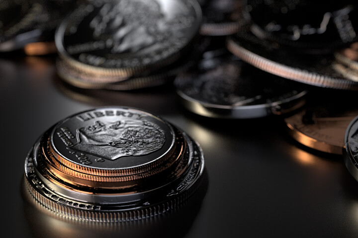 U.S. coins stacked in foreground with random coins piled in background