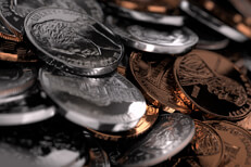 Close-up picture of U.S. coins randomly piled on surface