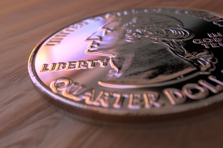 U.S. quarter lying on wood table with nice window reflection
