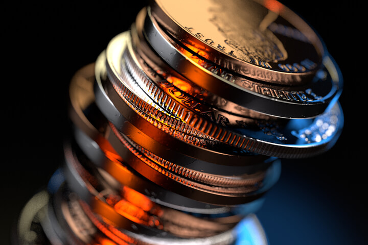 Large stack of U.S. coins on black background with sharp orange and blue contrasting lighting at camera angle