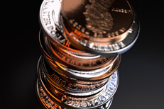 Large stack of U.S. coins top view looking down at dark background